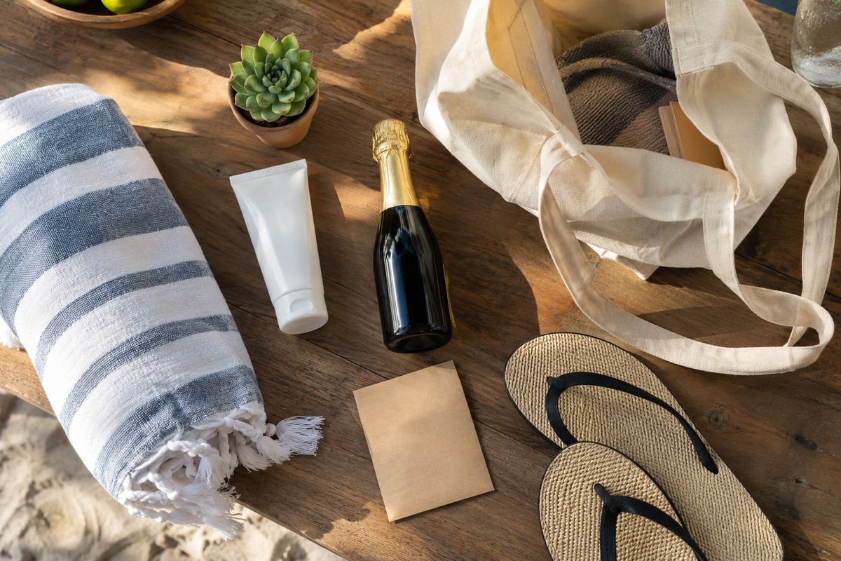 Beach wedding welcome bag contents laid out on a table.