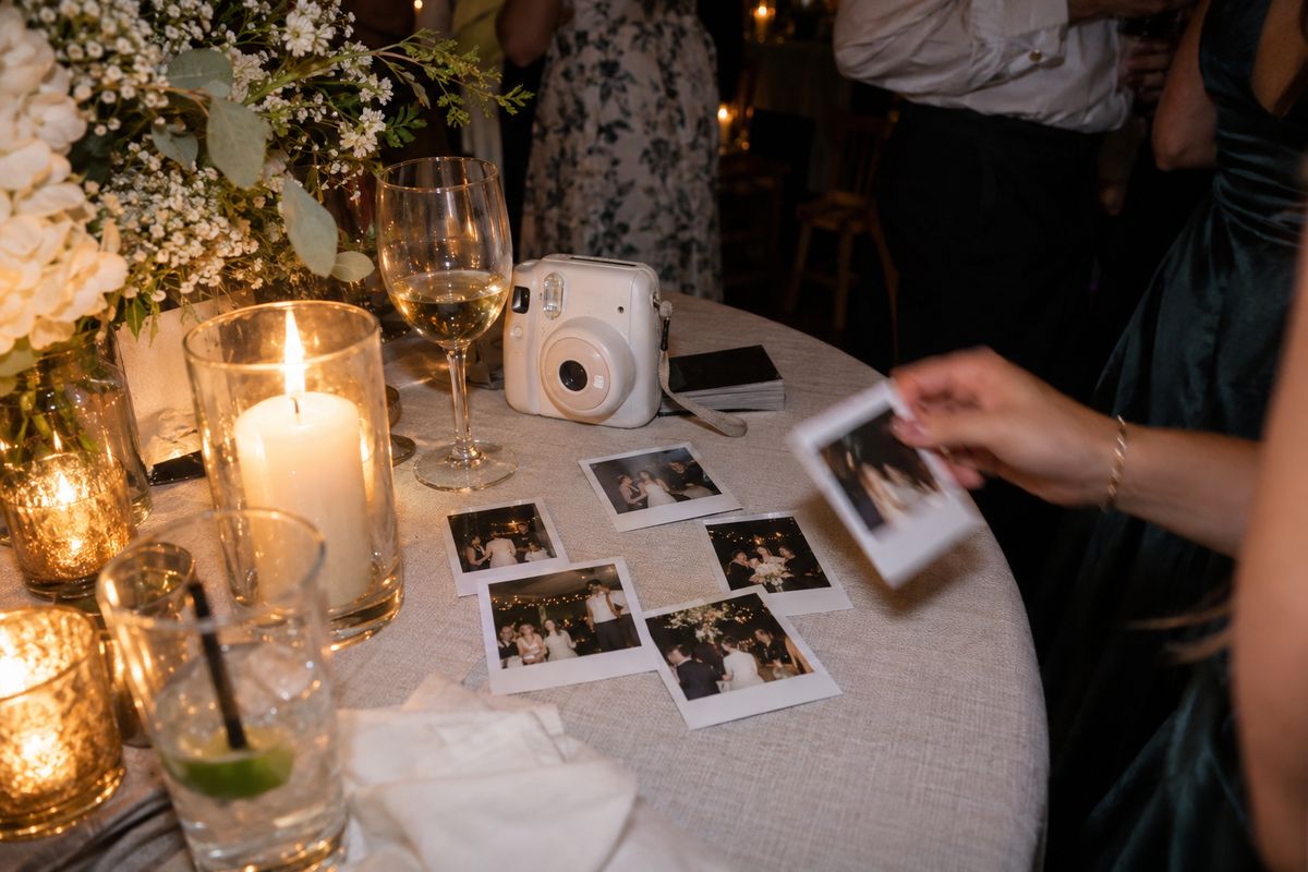 Guests' instant-camera prints drying on a reception table.