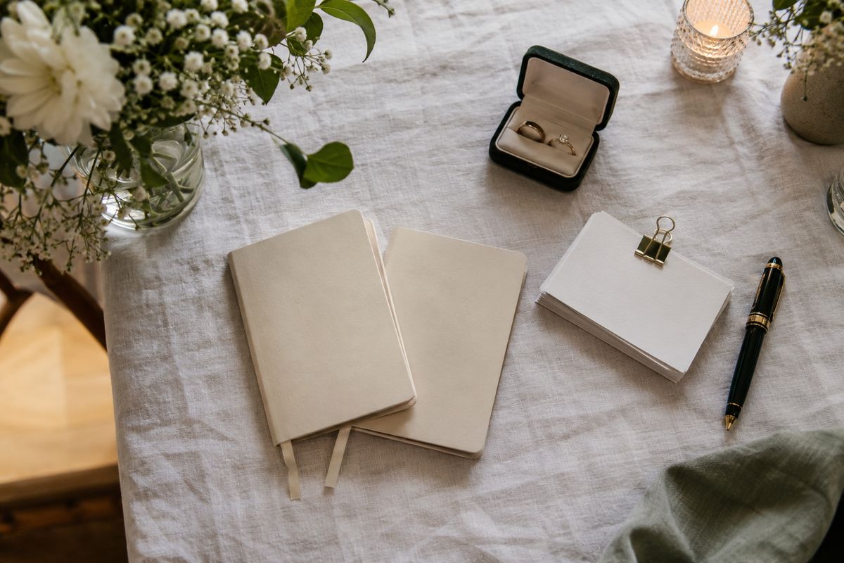 Vow books and index cards laid out on a table before a wedding ceremony.